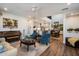 Open concept living room features comfortable seating, piano, kitchen, stairs to the second floor and bright, neutral decor at 3855 S Mcqueen Rd # 101, Chandler, AZ 85286