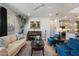 This cozy living room has neutral tones, a comfortable sofa and chairs, a piano and lots of natural light at 3855 S Mcqueen Rd # 101, Chandler, AZ 85286