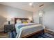 Primary bedroom featuring a king bed, ensuite bathroom, and elegant decor at 3855 S Mcqueen Rd # 101, Chandler, AZ 85286
