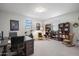 Spacious office space with a desk, chair, bookshelves, and comfortable seating area at 3855 S Mcqueen Rd # 101, Chandler, AZ 85286