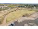 Aerial view of a grassy community park with walking paths, mature trees, and open space for recreation at 3855 S Mcqueen Rd # 101, Chandler, AZ 85286