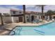 Inviting community pool area featuring colorful lounge chairs and well-maintained landscaping at 3855 S Mcqueen Rd # 101, Chandler, AZ 85286