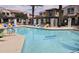 Community pool with colorful lounge chairs and shaded area with a view of the community townhomes at 3855 S Mcqueen Rd # 101, Chandler, AZ 85286