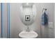 Stylish powder room with pedestal sink, designer mirror, and elegant decor at 3855 S Mcqueen Rd # 101, Chandler, AZ 85286