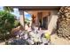 Charming covered patio featuring a dining set, sliding doors, and desert landscaping with cacti and blooming flowers at 3928 N 151St Ave, Goodyear, AZ 85395