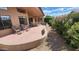 Inviting back patio with comfortable seating and a pathway surrounded by lush greenery and natural desert landscaping at 3928 N 151St Ave, Goodyear, AZ 85395