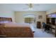 Cozy bedroom with a queen-sized bed, a window with natural light, and a desk area for work or study at 3928 N 151St Ave, Goodyear, AZ 85395