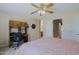 Cozy bedroom with a queen-sized bed, a window with natural light, and a desk area for work or study at 3928 N 151St Ave, Goodyear, AZ 85395