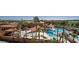 Aerial view of a community pool, with shade covers, lined with palm trees, near the golf course at 3928 N 151St Ave, Goodyear, AZ 85395