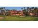 Stunning community golf course with meticulously manicured green, sand traps, and mature palm trees at 3928 N 151St Ave, Goodyear, AZ 85395