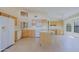 Bright, open kitchen with light wood cabinetry, a center island, modern appliances, and ample natural light at 3928 N 151St Ave, Goodyear, AZ 85395