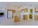 Spacious kitchen with light wood cabinets, white appliances, a center island, and tile flooring at 3928 N 151St Ave, Goodyear, AZ 85395