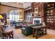 Cozy community library with fireplace, dark wood bookcases, plush seating, and a large window at 3928 N 151St Ave, Goodyear, AZ 85395