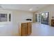 Spacious room with tile flooring, vaulted ceiling, kitchen island, and sliding doors that lead to a patio at 3928 N 151St Ave, Goodyear, AZ 85395