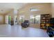 Bright living room features large windows, neutral colors, tile flooring, and comfortable seating arrangements at 3928 N 151St Ave, Goodyear, AZ 85395