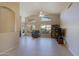 Bright and airy living area featuring tile floors, high ceilings, and large windows offering plenty of natural light at 3928 N 151St Ave, Goodyear, AZ 85395