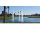 Scenic pond with water features, lush greenery, and rolling hills, adding tranquility to the community at 3928 N 151St Ave, Goodyear, AZ 85395