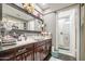 Elegant bathroom features a vanity, decorative mirror, and a shower stall at 4112 E Maldonado Dr, Phoenix, AZ 85042