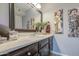 Charming bathroom featuring a marble countertop, decorative mirror, and modern faucet at 4112 E Maldonado Dr, Phoenix, AZ 85042