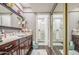 Well-lit bathroom with vanity, mirror, and walk-in shower with glass door at 4112 E Maldonado Dr, Phoenix, AZ 85042