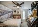 Comfortable bedroom boasts a ceiling fan, a mounted TV, and decorative wall art at 4112 E Maldonado Dr, Phoenix, AZ 85042
