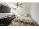 Comfortable bedroom with a ceiling fan and mounted TV above a dresser at 4112 E Maldonado Dr, Phoenix, AZ 85042