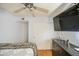 This bedroom features a ceiling fan, mounted TV, and a closet with sliding doors at 4112 E Maldonado Dr, Phoenix, AZ 85042
