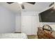 Cozy bedroom features a ceiling fan, large closet with sliding doors, and a mounted TV at 4112 E Maldonado Dr, Phoenix, AZ 85042