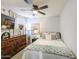 Charming bedroom with a dresser, bed with decorative pillows and throws, and a ceiling fan at 4112 E Maldonado Dr, Phoenix, AZ 85042
