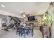 Dining area with a unique brick fireplace, flat screen TV and staircase with an black iron railing at 4112 E Maldonado Dr, Phoenix, AZ 85042