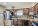 Charming kitchen featuring stainless appliances, granite counters, and dark wood cabinetry at 4112 E Maldonado Dr, Phoenix, AZ 85042
