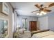 Bright main bedroom features ceiling fan, ensuite bath, and neutral decor at 4112 E Maldonado Dr, Phoenix, AZ 85042