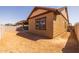 Exterior view of the backyard showing dirt ground and a rear view of the home at 4320 E Bernice St, Gilbert, AZ 85295