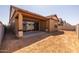 A spacious backyard featuring a covered patio and views of the surrounding neighborhood at 4320 E Bernice St, Gilbert, AZ 85295