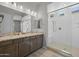 Bathroom with double vanity, wood cabinets, granite countertop and glass shower with seat at 4320 E Bernice St, Gilbert, AZ 85295