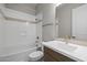 Bathroom featuring a shower-tub combo with tiled accents and a single sink vanity at 4320 E Bernice St, Gilbert, AZ 85295
