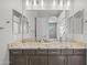 Bathroom with double vanity, wood cabinets, granite countertop and a large mirror at 4320 E Bernice St, Gilbert, AZ 85295