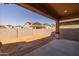 Covered patio looking out to an empty, dirt backyard ready to be transformed at 4320 E Bernice St, Gilbert, AZ 85295