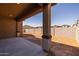 Rear covered patio providing shade in a backyard with block wall fencing at 4320 E Bernice St, Gilbert, AZ 85295