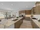 Kitchen island with granite countertops, stainless steel appliances, and a view of the dining area at 4320 E Bernice St, Gilbert, AZ 85295