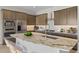 Kitchen island with granite countertops, stainless steel appliances, and wooden cabinets at 4320 E Bernice St, Gilbert, AZ 85295