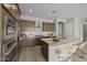 Well-lit kitchen with wood cabinets, granite countertops, stainless appliances and seating at the island at 4320 E Bernice St, Gilbert, AZ 85295