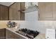 Well-equipped kitchen featuring stainless steel appliances, stone countertops, and a custom range at 4320 E Bernice St, Gilbert, AZ 85295