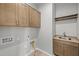 The laundry room features upper cabinets, a sink with modern fixtures, and washer/dryer hookups at 4320 E Bernice St, Gilbert, AZ 85295