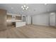 Bright, open-concept living space featuring a kitchen with stainless steel appliances and light wood flooring at 4320 E Bernice St, Gilbert, AZ 85295