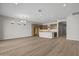 Open concept living room with hardwood floors, recessed lighting, and a kitchen with stainless steel appliances at 4320 E Bernice St, Gilbert, AZ 85295
