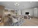 Stylized view of the living area featuring modern decor and an open concept to the kitchen and dining area at 4320 E Bernice St, Gilbert, AZ 85295
