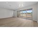 Spacious living room featuring wood-look floors, recessed lighting, and large sliding glass doors at 4320 E Bernice St, Gilbert, AZ 85295