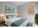 The main bedroom features a queen bed, matching lamps, and a painting over the headboard at 4320 E Bernice St, Gilbert, AZ 85295