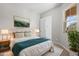 The main bedroom features a queen bed, lamps, wall art, and a large green plant at 4320 E Bernice St, Gilbert, AZ 85295
